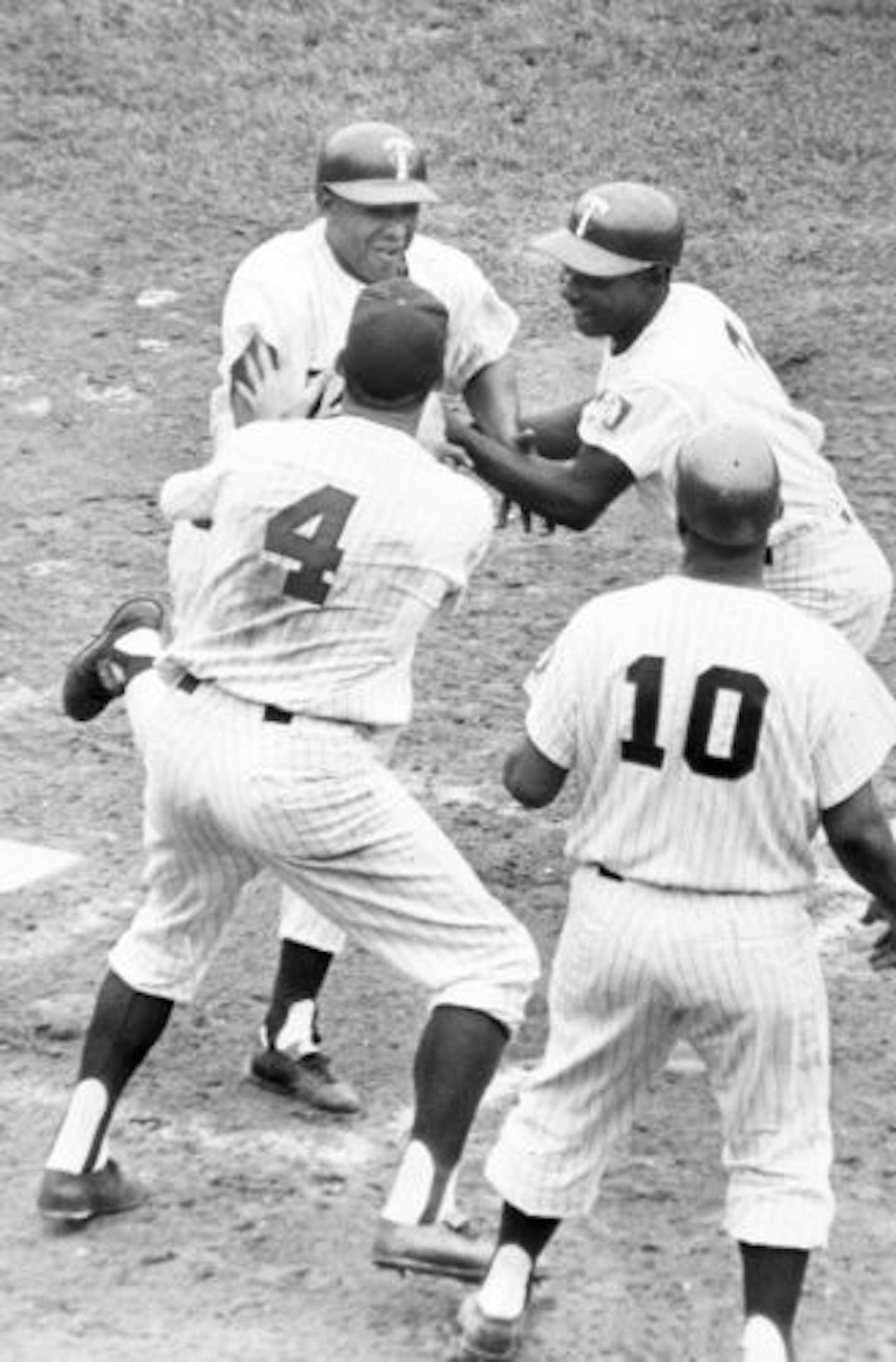 Julio Becquer is greeted by Bob Allison(4) and Earl Battey(10) after Becquer's 7/4/61 Grand Slam.