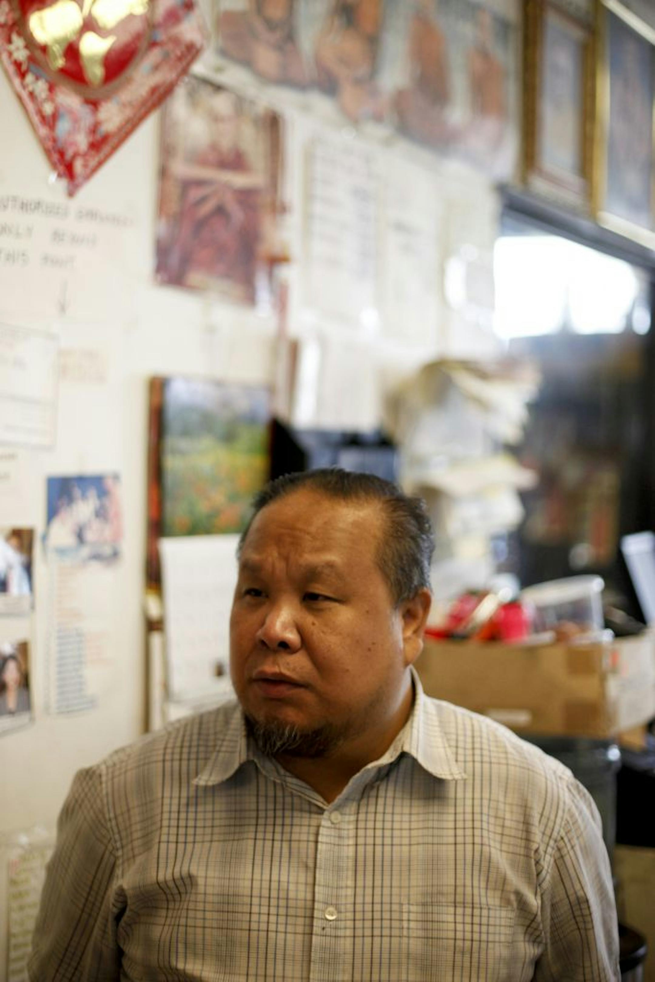 Owner of 2812 First Ave. S. Cy Ratsamy, 46, stands in his store New Orient Market around the corner from his rented home that caught on fire early this morning in Minneapolis, Minn. on Saturday July 28, 2012.