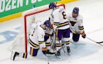 Minnesota State's Jack McNeely (3), Sam Morton (6) and Wyatt Aamodt (7) stand by goalie Dryden McKay, behind, after the team's loss to Denver in the N