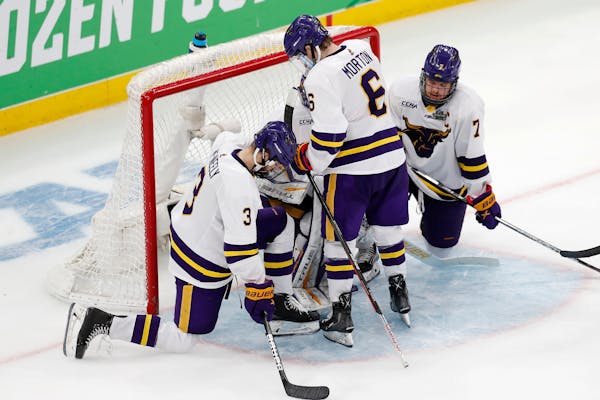 Minnesota State's Jack McNeely (3), Sam Morton (6) and Wyatt Aamodt (7) stand by goalie Dryden McKay, behind, after the team's loss to Denver in the N