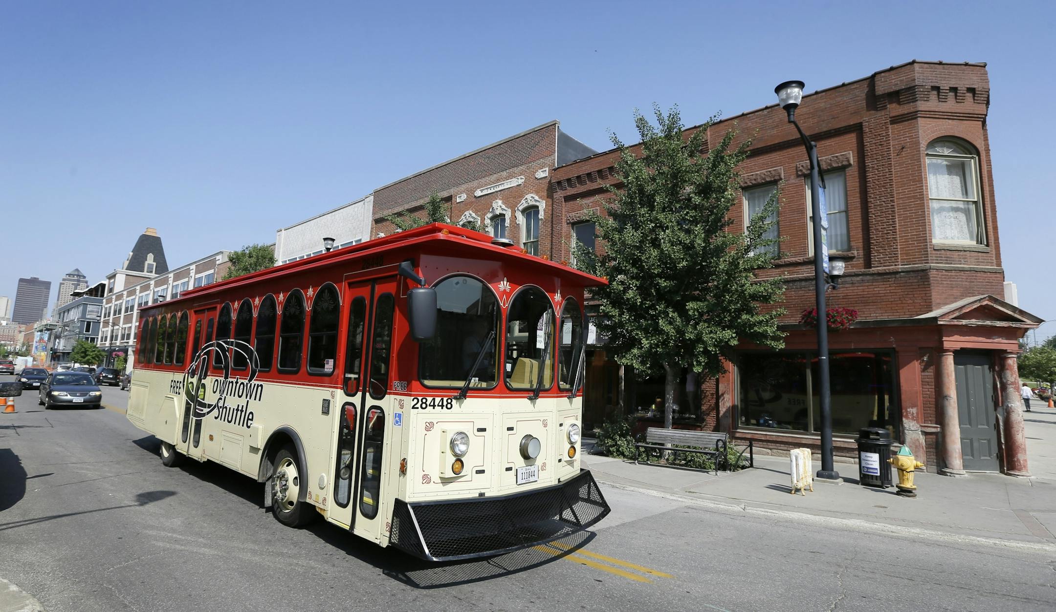 This July 10, 2014 photo shows the free downtown shuttle moving through the historic East Village district, in Des Moines, Iowa. Nestled in the middle of Iowa, surrounded by miles of rolling hills green with corn and soybeans, is the capital city of Des Moines. A metropolis thatís experienced a popularity surge in recent years thanks to new businesses and housing opportunities, Des Moines has plenty of activities that will be kind to your wallet. (AP Photo/Charlie Neibergall)