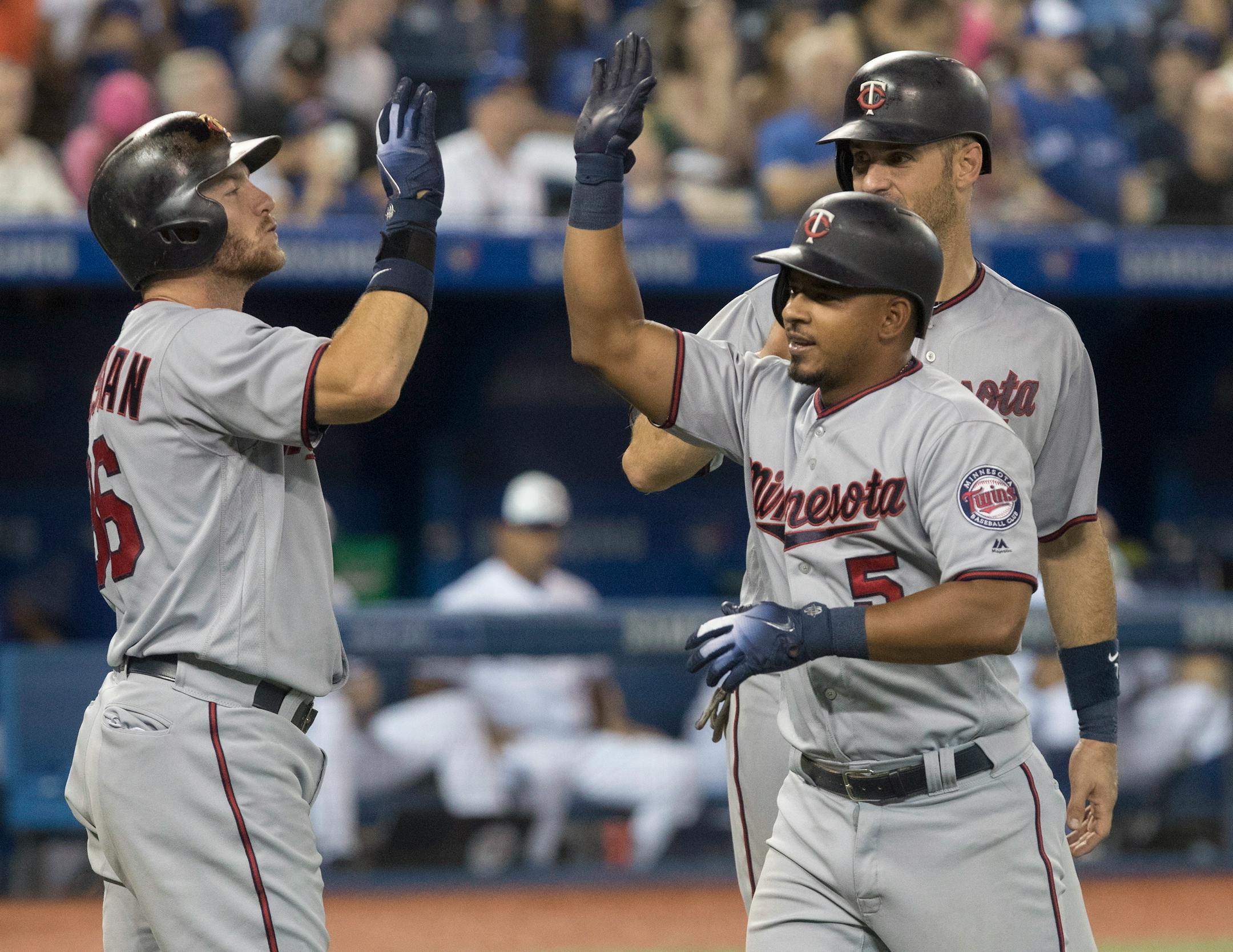 Eduardo Escobar is congratulated by teammates after he hit a three run home run against the Blue Jays in the eighth inning