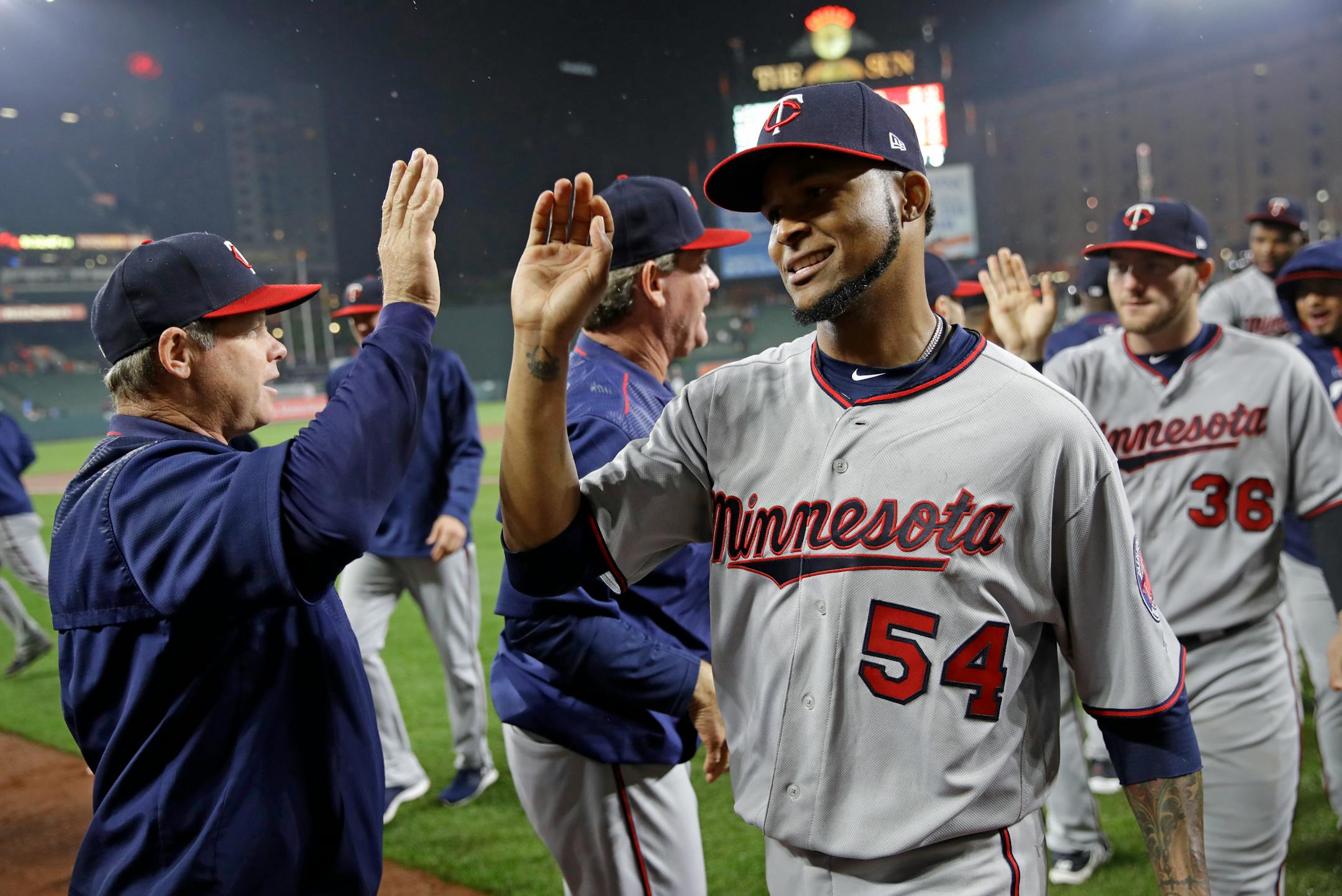 Minnesota Twins starting pitcher Ervin Santana (54) celebrates with coaches and teammates after closing out a baseball game against the Baltimore Orioles in Baltimore, Tuesday, May 23, 2017. Santana pitched nine complete innings in Minnesota's 2-0 win. (AP Photo/Patrick Semansky)