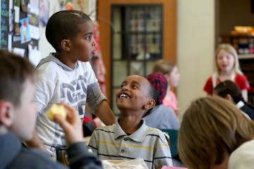 Barton Open School students in a combination third- and fourth-grade class taught by Jaci Sullivan socialized while eating lunch in their classroom th