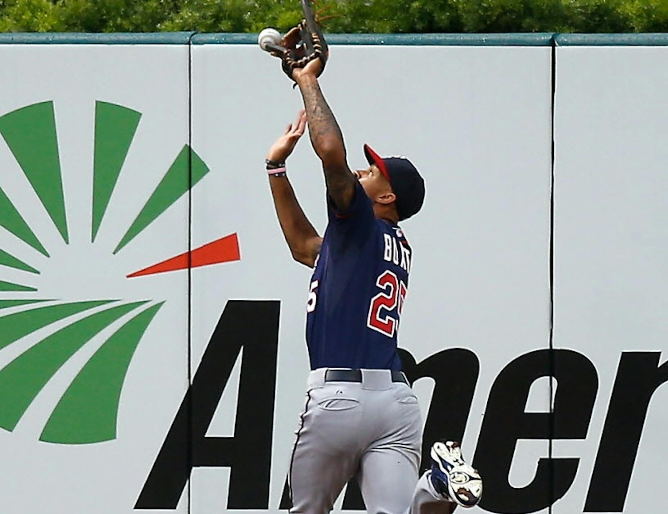 Minnesota Twins center fielder Byron Buxton is unable to catch a ball hit by St. Louis Cardinals' Randal Grichuk for a triple during the third inning of a baseball game to Monday, June 15, 2015, in St. Louis.