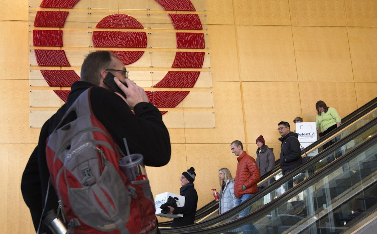 Target employees were once again filing out of Target Corporate headquarters in Downtown Minneapolis Wednesday afternoon with boxes of personal belongings after Target Corp. announced they would be laying off about 550 employees who work in the Twin Cities as it continues to wind down its Canadian business. ] BRIAN PETERSON &#x2022; brianp@startribune.com Minneapolis, MN - 2/11/2015 ORG XMIT: MIN1502111320322508