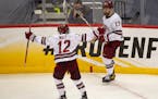 Massachusetts forward Garrett Wait (12) celebrated with Philip Lagunov after Lagunov's shorthanded goal in the second period made it 3-0.