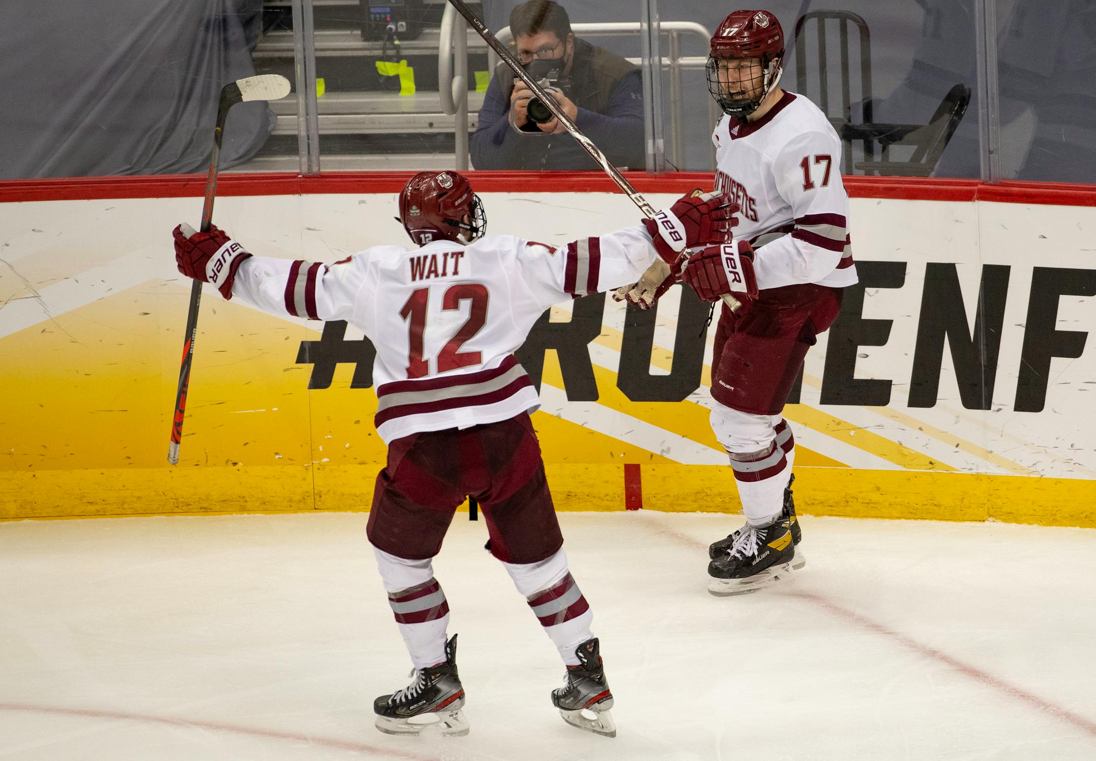 Massachusetts forward Garrett Wait (12) celebrated with Philip Lagunov after Lagunov's shorthanded goal in the second period made it 3-0.
