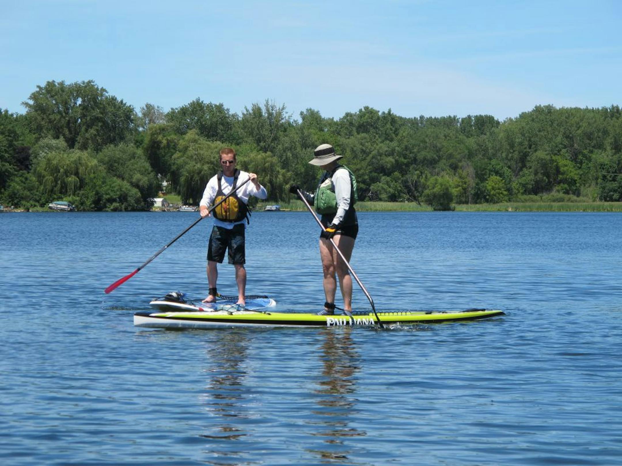 Dave Englund gives a paddleboarding lesson to Cindy Terry of Robbinsdale on a recent Monday at Tanners Lake in Oakdale
Photo: Tim Harlow