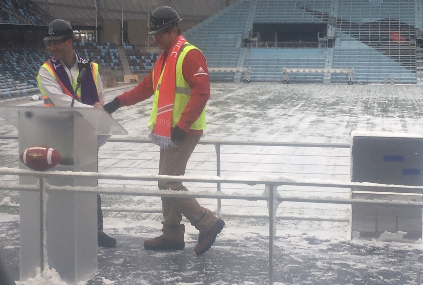 St. Thomas head coach Glenn Caruso (left) and St. John's head coach Gary Fasching (right) shake hands at Allianz Field on Monday at the announcement of the football game there for 2019.