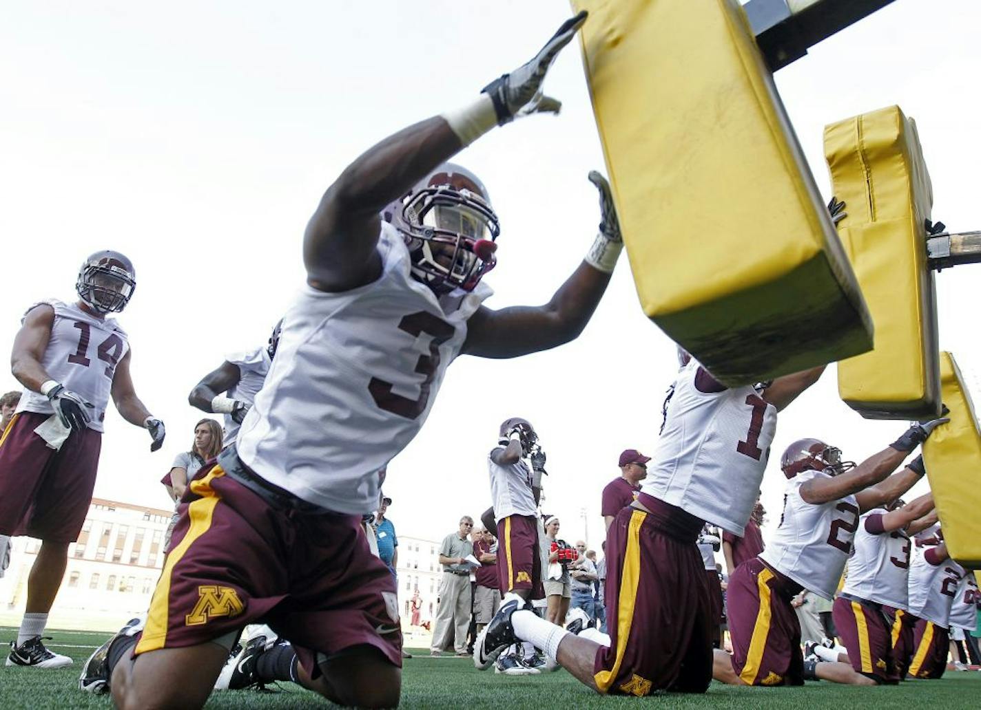 Kim Royston (3) and teammates worked on the sled during Monday's opening practice for the Gophers football team.