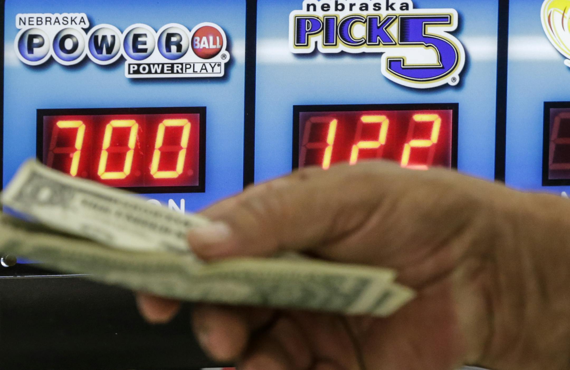 A customer hands over money for a Powerball ticket in Omaha, Neb., on Wednesday night.