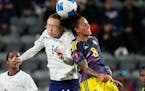 United States midfielder Emily Sonnett, left, vies for a a head ball against Colombia midfielder Marcela Restrepo during the second half Sunday in Los
