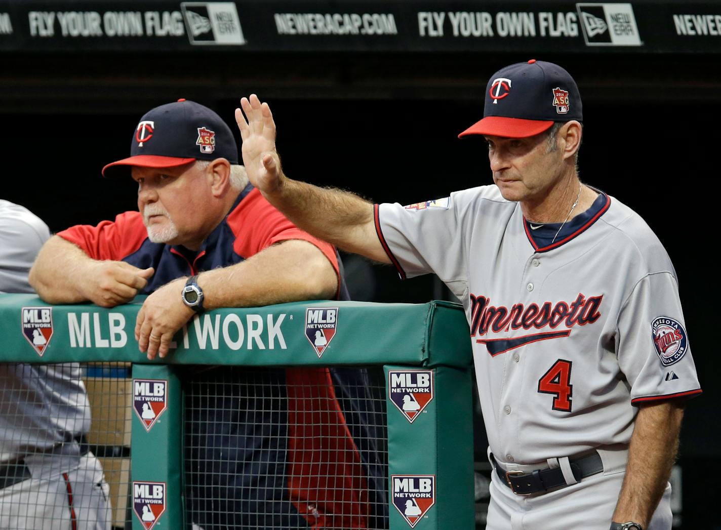 FILE - In this Sept. 9, 2014, file photo, Minnesota Twins coach Paul Molitor (4) positions his fielders as he watches from the dugout with manager Ron Gardenhire, left, in the first inning of a baseball game against the Cleveland Indians in Cleveland. The Twins say, Monday, Nov. 3, 2014, they will hire Molitor as manager after four straight seasons of 92 or more losses. The Twins said the 58-year-old Molitor will be introduced at a news conference Tuesday and given a three-year contract. He replaces Gardenhire, who was fired five weeks ago.(AP Photo/Mark Duncan, File)