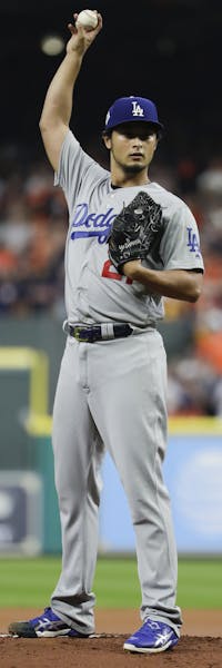 Los Angeles Dodgers starting pitcher Yu Darvish, of Japan, throws against the Houston Astros during the first inning of Game 3 of baseball's World Ser