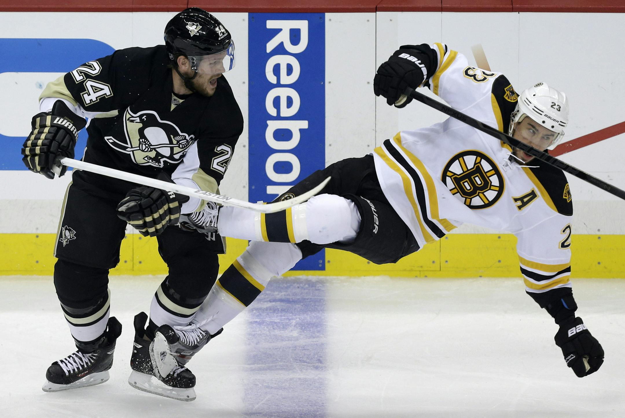 Pittsburgh Penguins' Matt Cooke (24) collides with Boston Bruins' Chris Kelly (23) in the first period of Game 2 of the NHL hockey Stanley Cup Eastern Conference finals in Pittsburgh Monday, June 3, 2013. (AP Photo/Gene J. Puskar) ORG XMIT: PAGP105