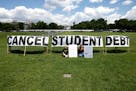 As college students around the country graduate with a massive amount of debt, advocates display a hand-painted signs and messages on the Ellipse in f
