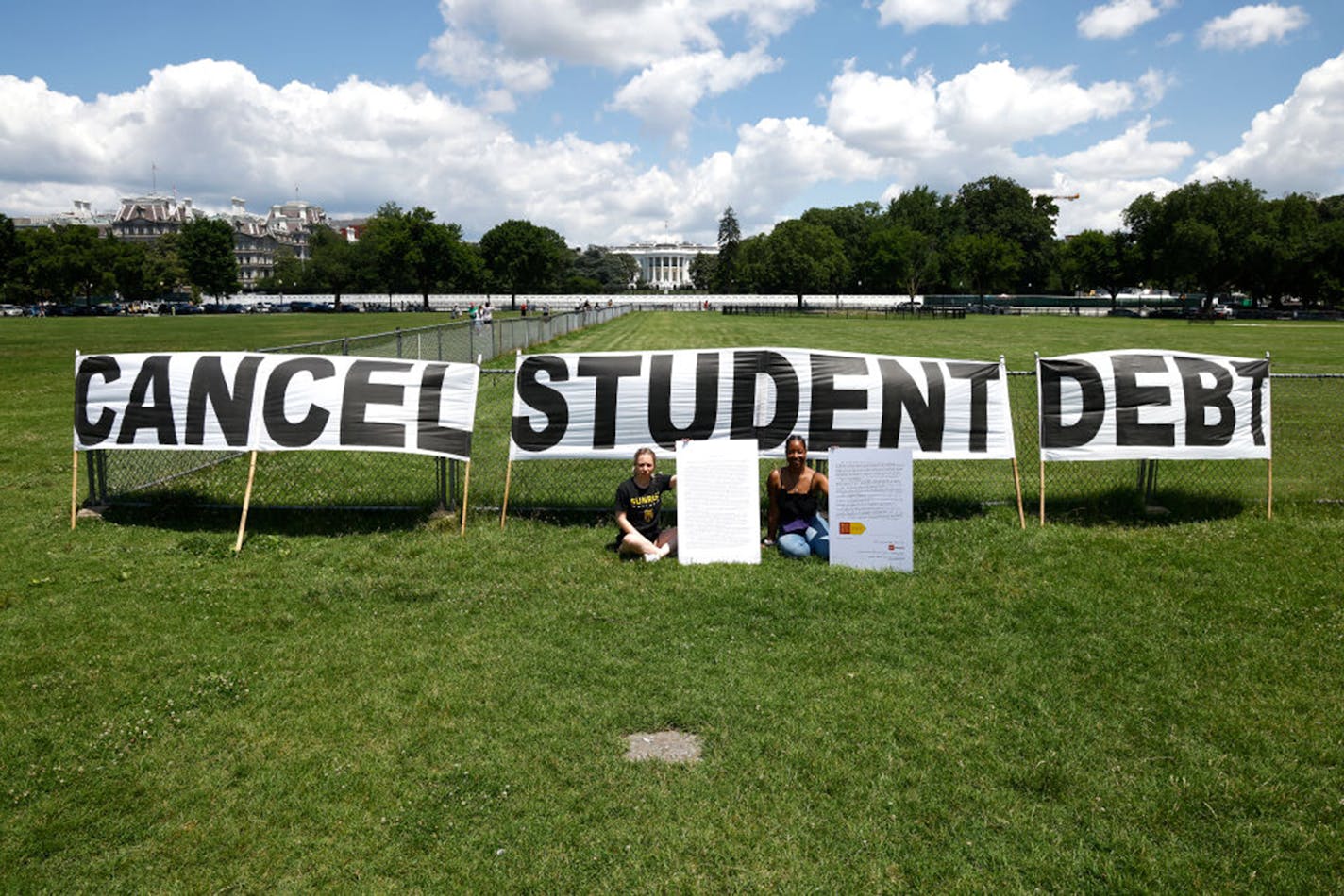 As college students around the country graduate with a massive amount of debt, advocates display a hand-painted signs and messages on the Ellipse in front of The White House to call on President Joe Biden to sign an executive order to cancel student debt on June 15, 2021 in Washington, DC. (Paul Morigi/Getty Images for We The 45 Million/TNS) ORG XMIT: 24096168W