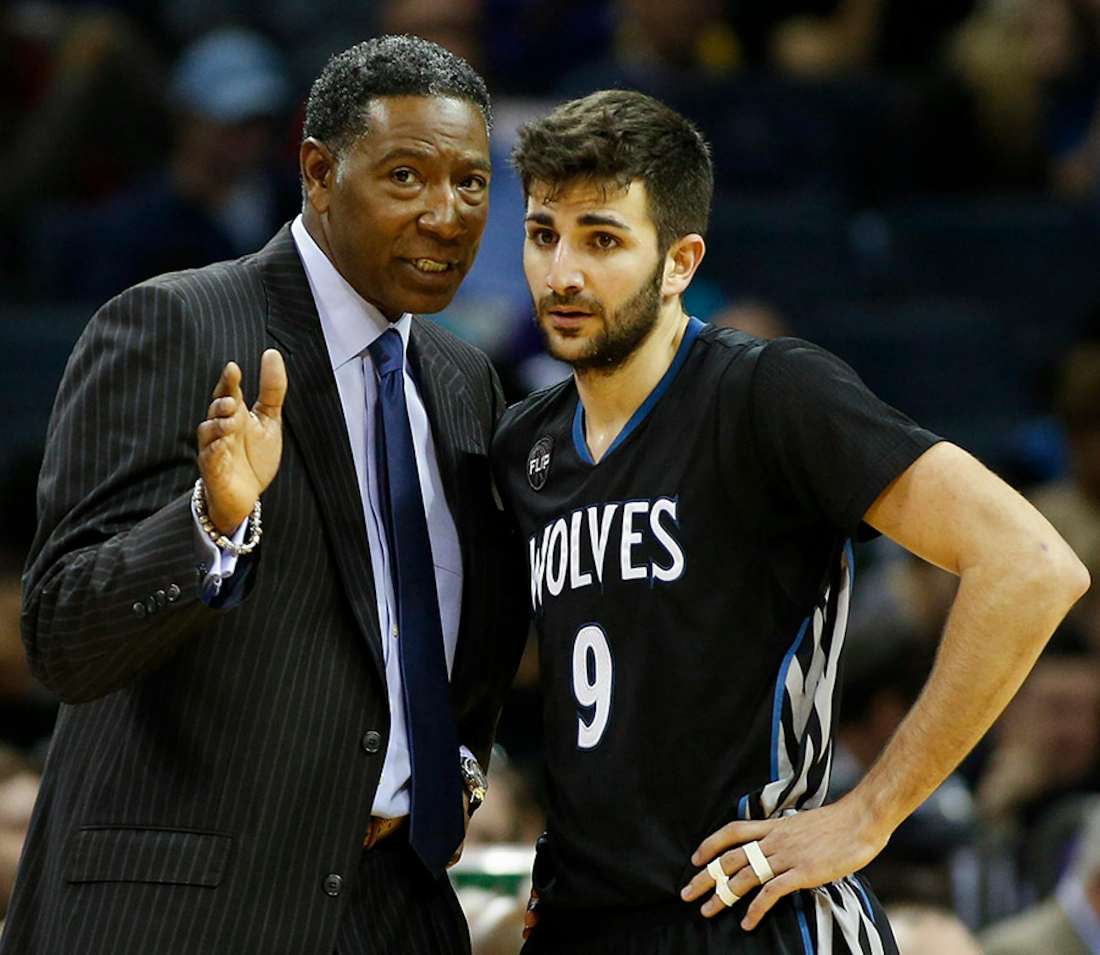 Minnesota Timberwolves coach Sam Mitchell, left, instructs guard Ricky Rubio as the Timberwolves play the Charlotte Hornets in the second half of an NBA basketball game in Charlotte, N.C., Monday, March 7, 2016. Charlotte won 108-103.