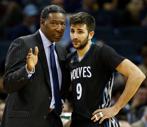 Minnesota Timberwolves coach Sam Mitchell, left, instructs guard Ricky Rubio as the Timberwolves play the Charlotte Hornets in the second half of an N