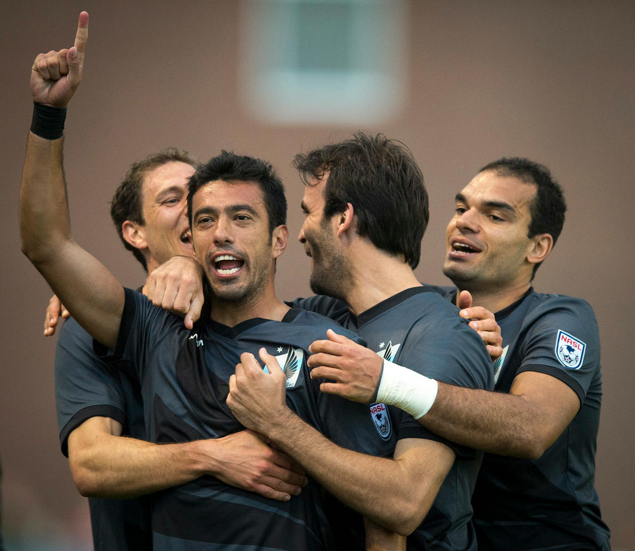 Minnesota FC Players embraced Tiago Calvano, second from left, after Calvano scored a goal against Jacksonville Armada FC in the second half. ] Aaron Lavinsky • aaron.lavinsky@startribune.com Minnesota United FC played Jacksonville on Saturday, May 23, 2015 at the National Sports Center in Blaine.