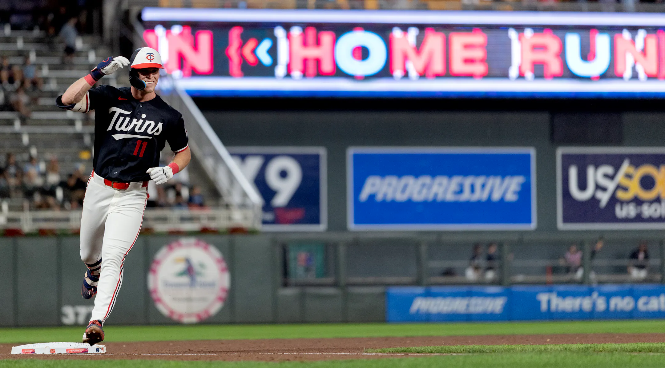 Walker Jenkins smiling while rounding third base after his first Major League home run for the Minnesota Twins