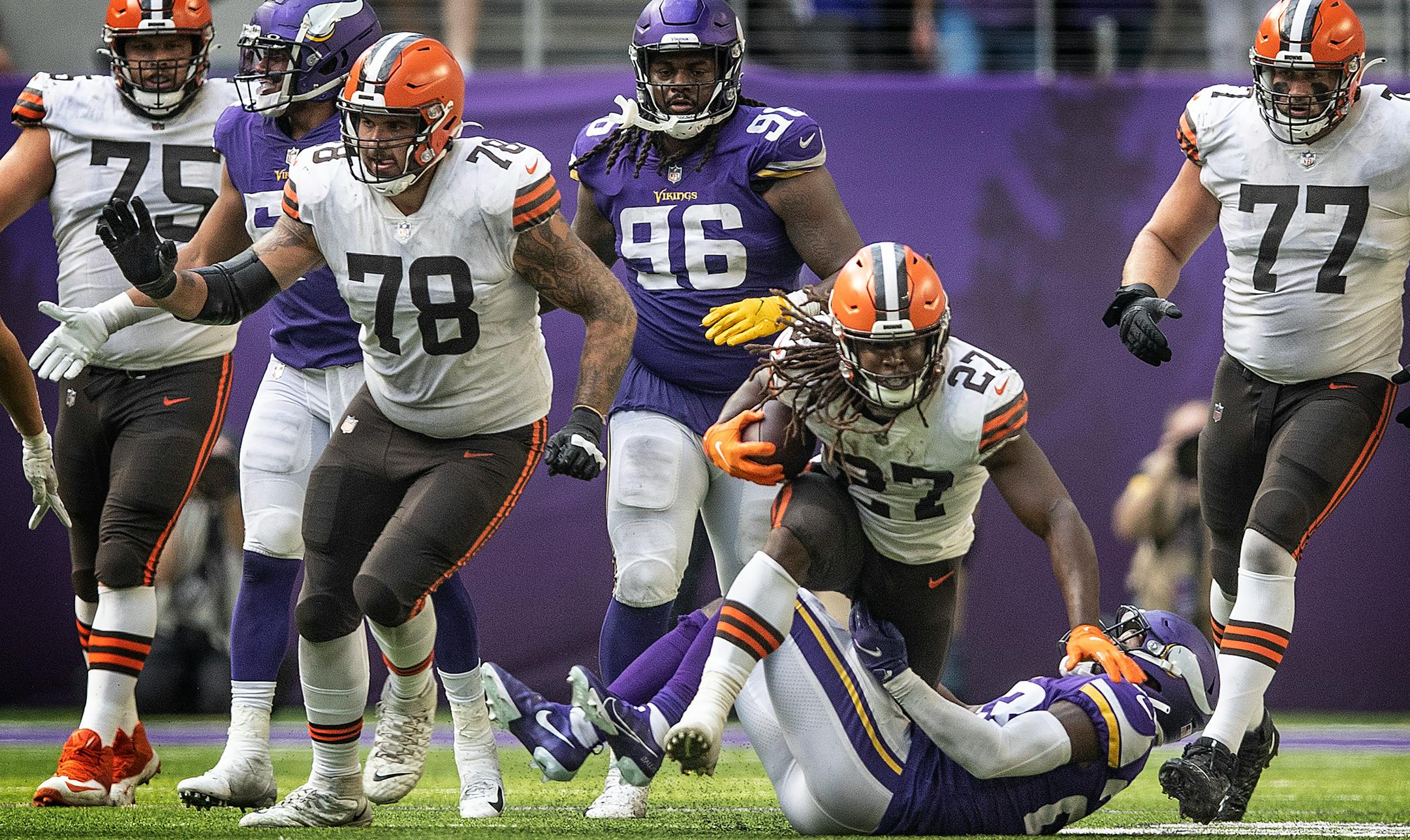 Cleveland Browns running back Kareem Hunt (27) was tripped up by Minnesota Vikings free safety Xavier Woods (23) in the fourth quarter.