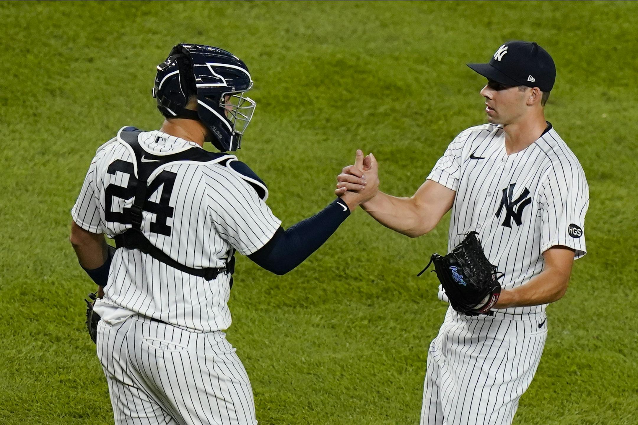 New York Yankees' Ben Heller, right, celebrates with catcher Gary Sanchez after a baseball game against the Boston Red Sox Friday, Aug. 14, 2020, in New York. The Yankees won 14-7. (AP Photo/Frank Franklin II)