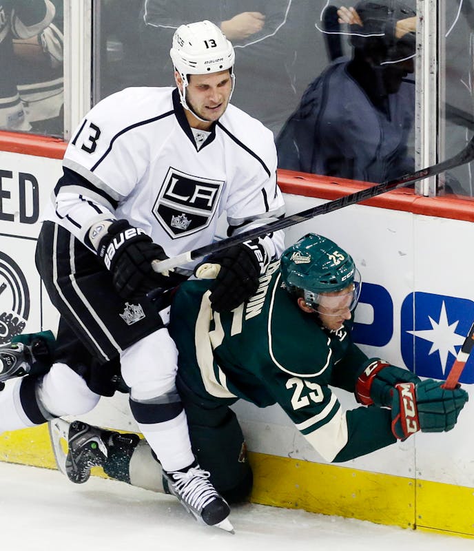 Minnesota Wild's Jonas Brodin (25) gets slammed into the boards by Los Angeles Kings' Kyle Clifford (13) during the first period of an NHL hockey game, Thursday, Oct. 3, 2013, in St. Paul, Minn. (AP Photo/Jim Mone)