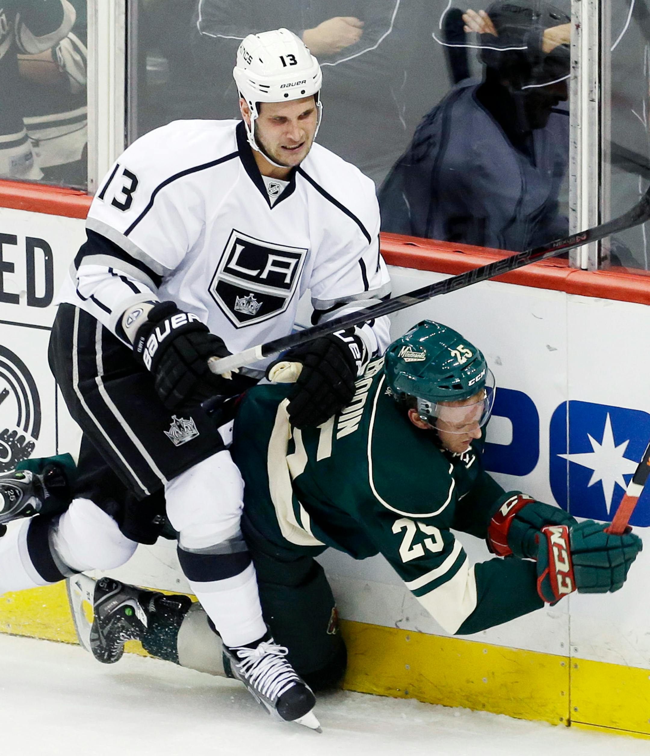 Minnesota Wild's Jonas Brodin (25) gets slammed into the boards by Los Angeles Kings' Kyle Clifford (13) during the first period of an NHL hockey game, Thursday, Oct. 3, 2013, in St. Paul, Minn. (AP Photo/Jim Mone)