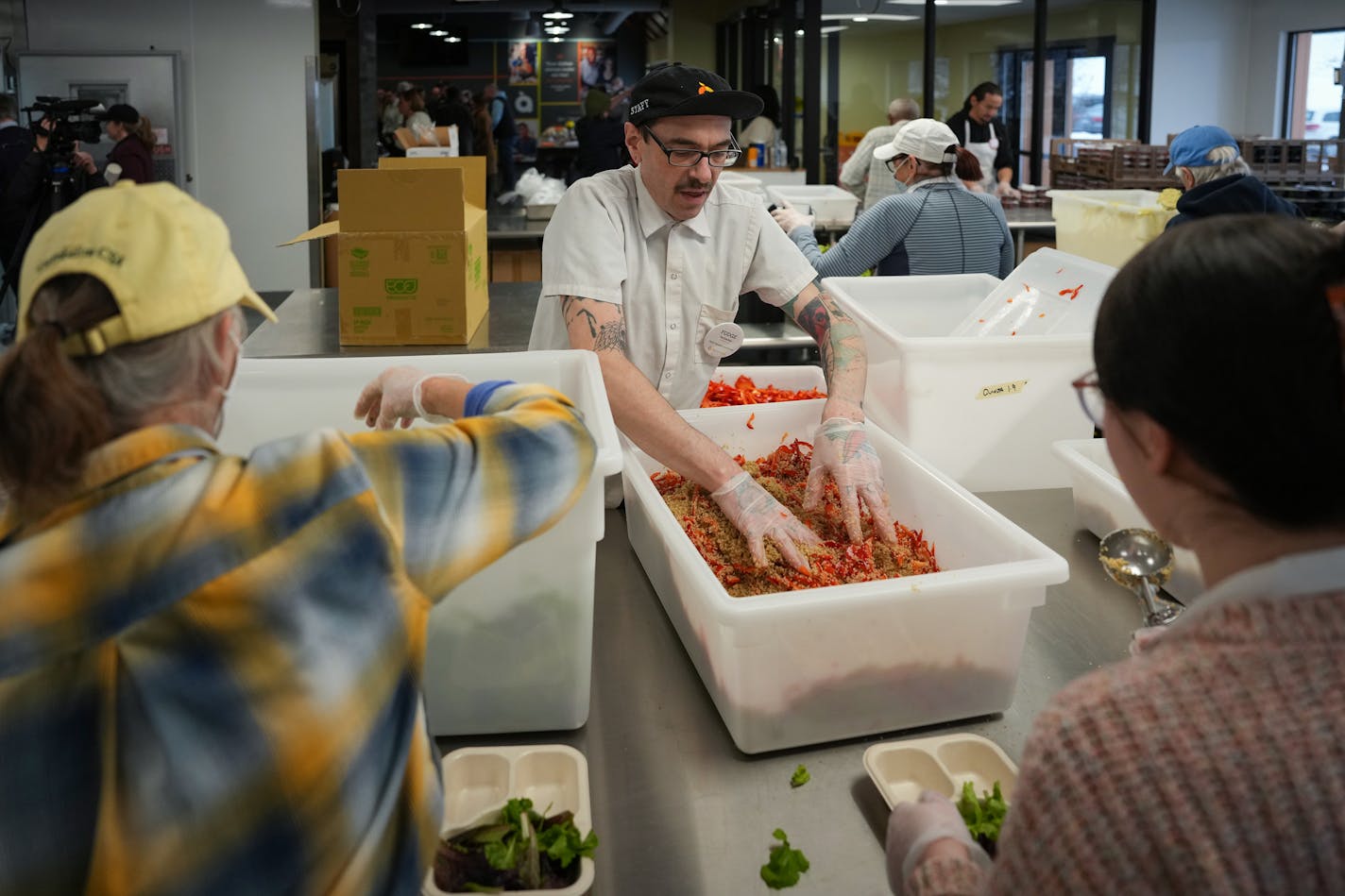 Open Arms chef and volunteer ambassador Matthew Fodge assists in prepping food at the nonprofit's new space in Saint Paul, Minn.