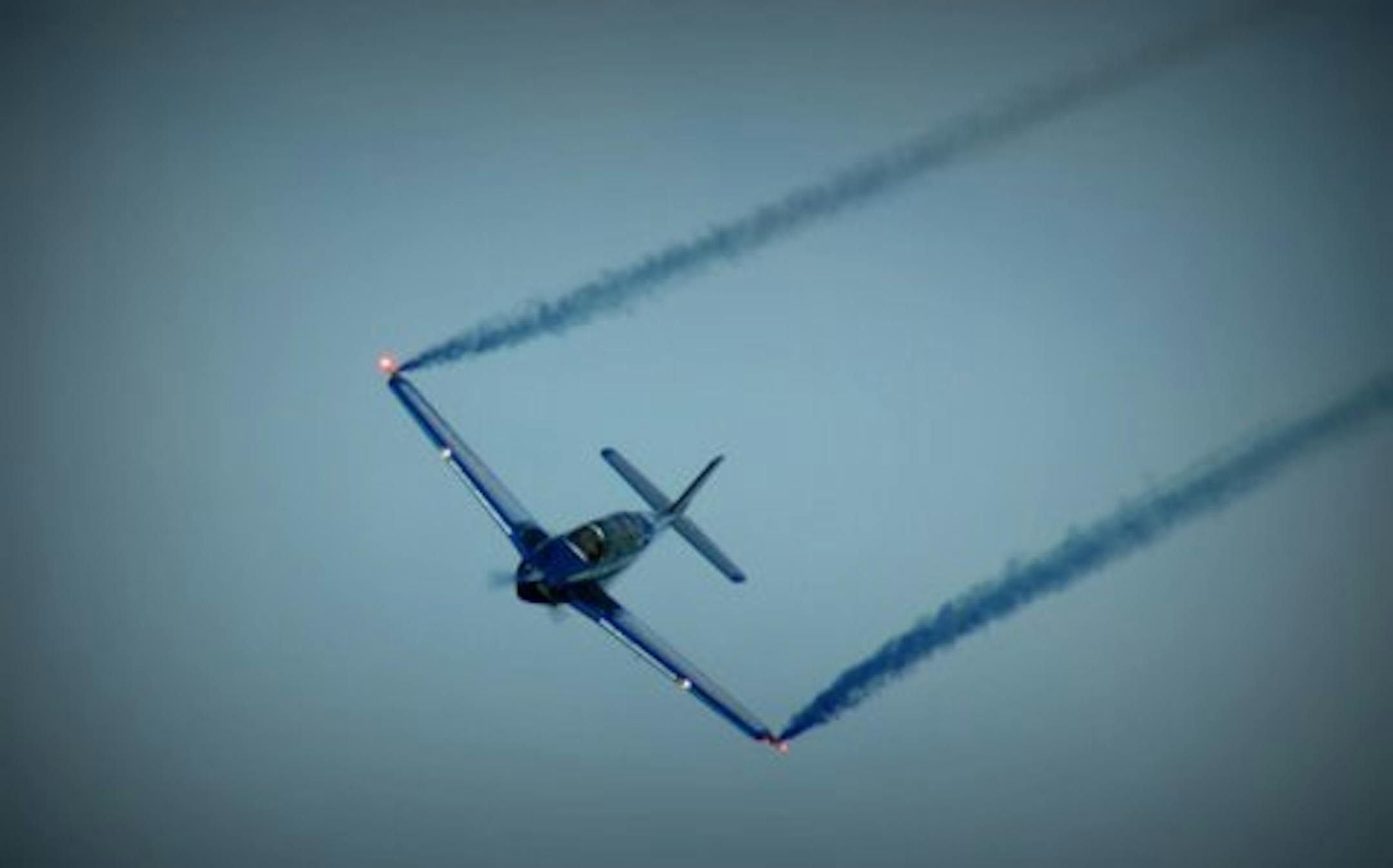 Courtesy Jerry Goodrich Aerobatic ace Julie Clark releases blue air-show smoke as she begins, then completes a low fly-by, breaking the news: ìItís a boy!î