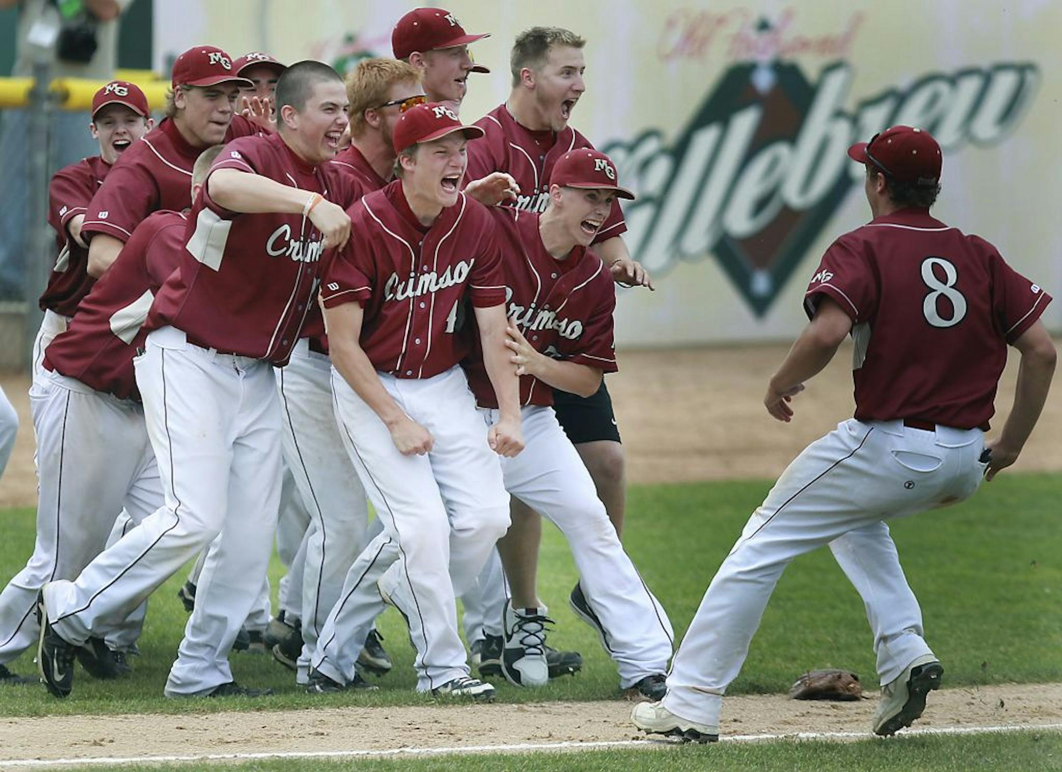 Maple Grove pitcher Jacob Schwager is surrounded by his teammates as they celebrated the win over Stillwater 4-1.