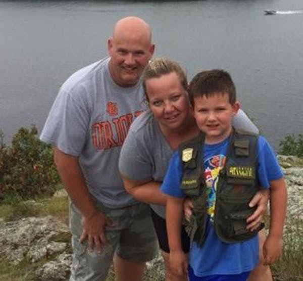 Wayzata officer William Allen Mathews with his wife and 7-year-old son.
