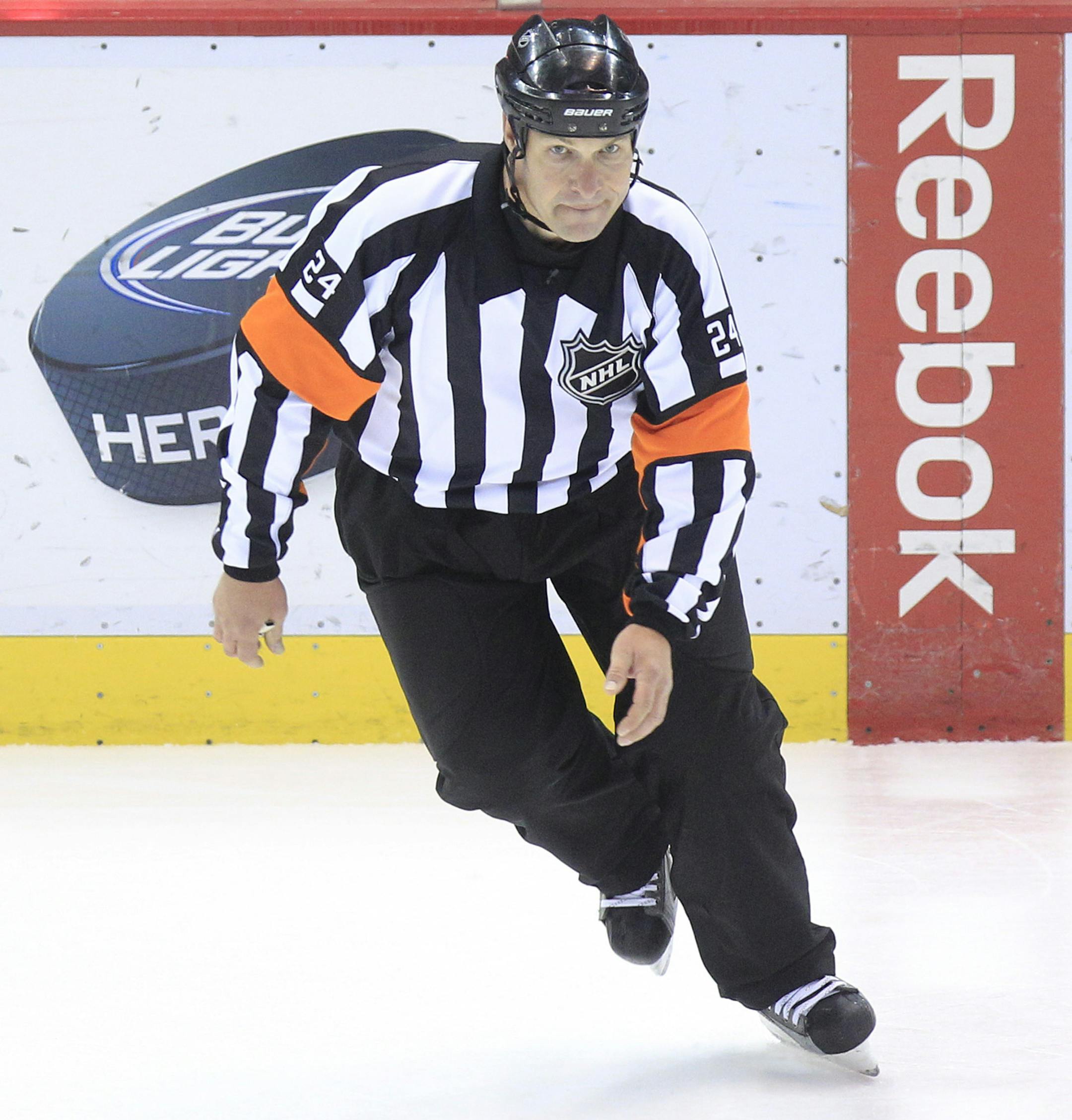 Referee Stephen Walkom (24) skates during the third period of an NHL hockey game between the Detroit Red Wings and the San Jose Sharks in Detroit, Sunday, Feb. 19, 2012. (AP Photo/Carlos Osorio) ORG XMIT: otkco126