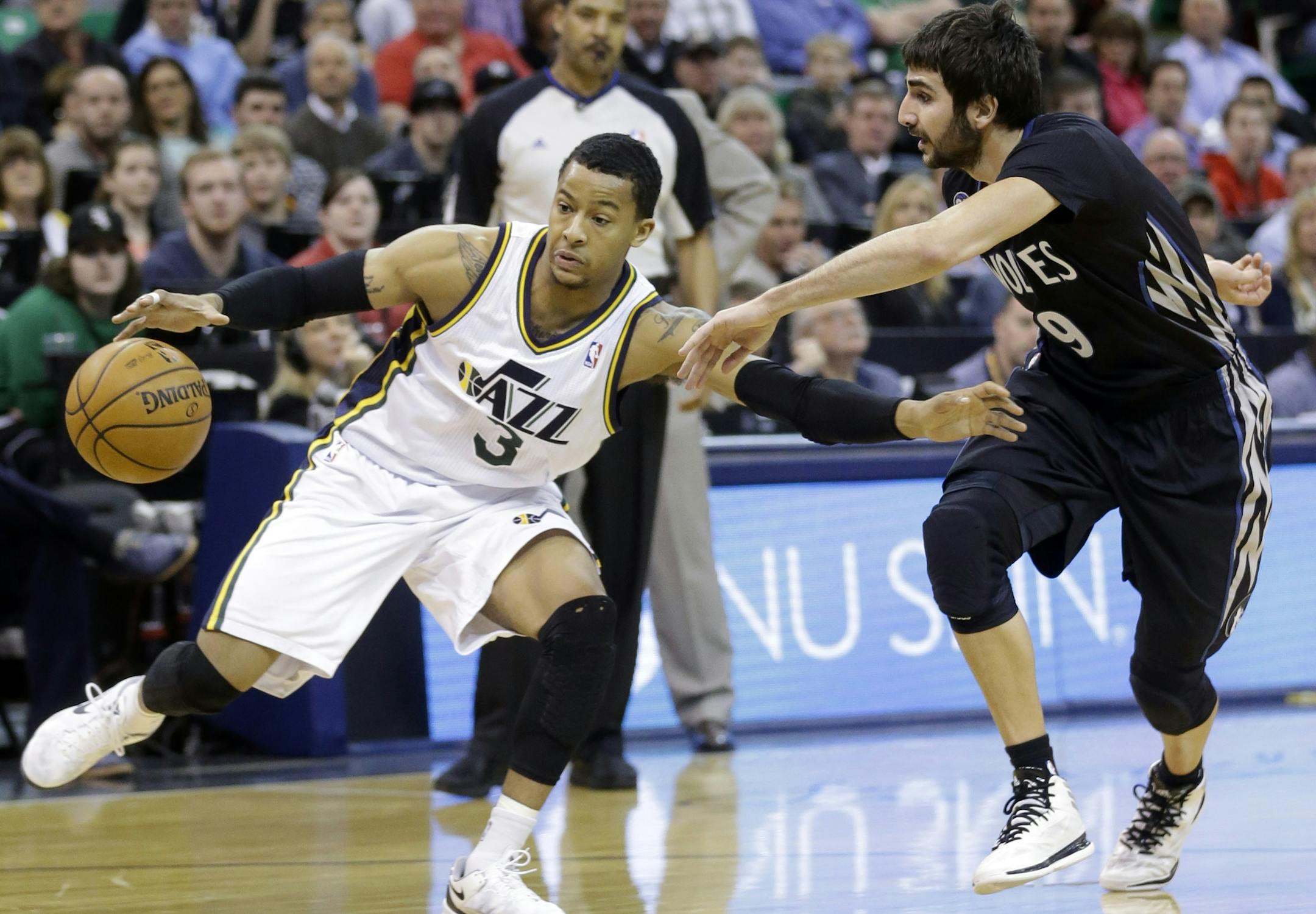 Minnesota Timberwolves' Ricky Rubio (9), of Spain, defends against Utah Jazz's Trey Burke (3) in the first quarter during an NBA basketball game, Tuesday, Jan. 21, 2014, in Salt Lake City. (AP Photo/Rick Bowmer)