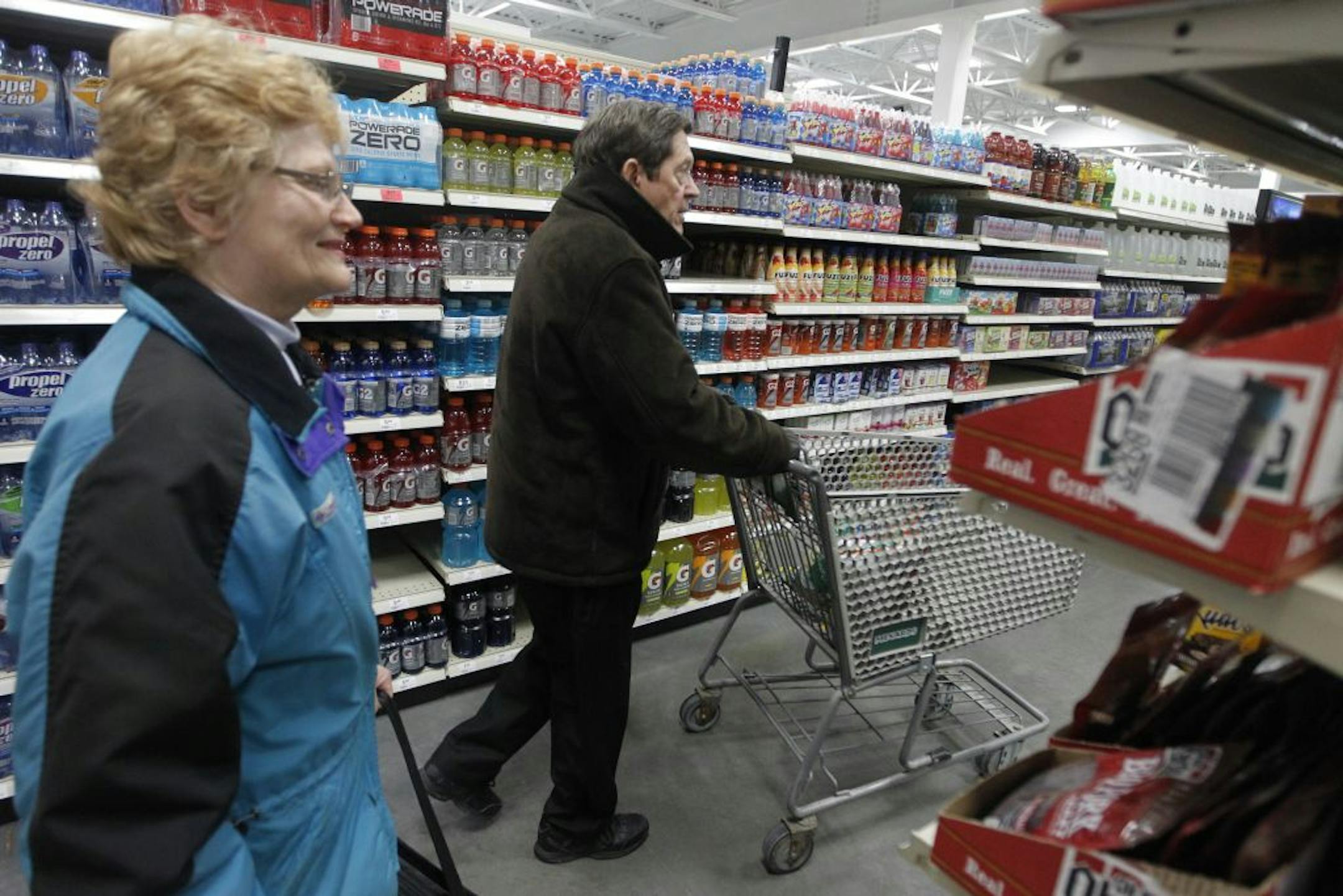 At the Menards in Eden Prairie, Janet Frahm looked around the grocery aisle as Marlan Carlson picked up some chips in his cart. The grocery section features popular snack items, frozen entrees, as well as fresh milk