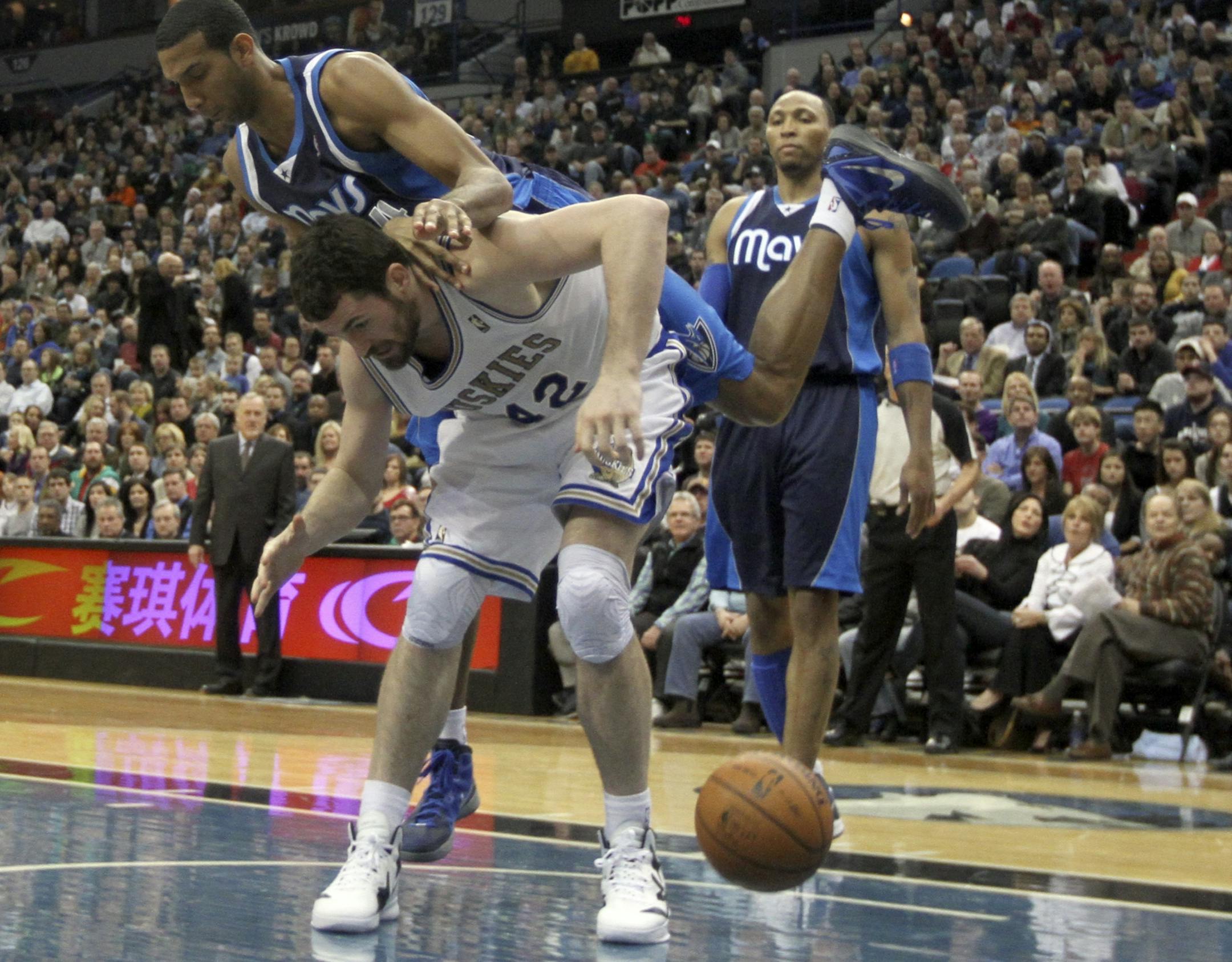 Timberwolves Kevin Love was fouled by Maverick's Brandan Wright during the first half at the Target Center inMinneapolis Min., Friday, February 10, 2012.