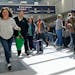 Travelers walk through the Minneapolis-St. Paul International Airport in April. Travel is roaring back this year. 