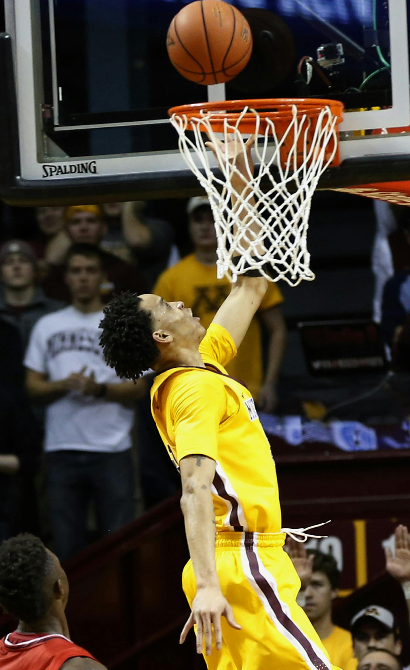 Minnesota's Amir Coffey, right, scores on a layup as St. John's Kassoum Yakwe watches during the first half of an NCAA college basketball game Friday, Nov. 18, 2016, in Minneapolis. (AP Photo/Jim Mone)