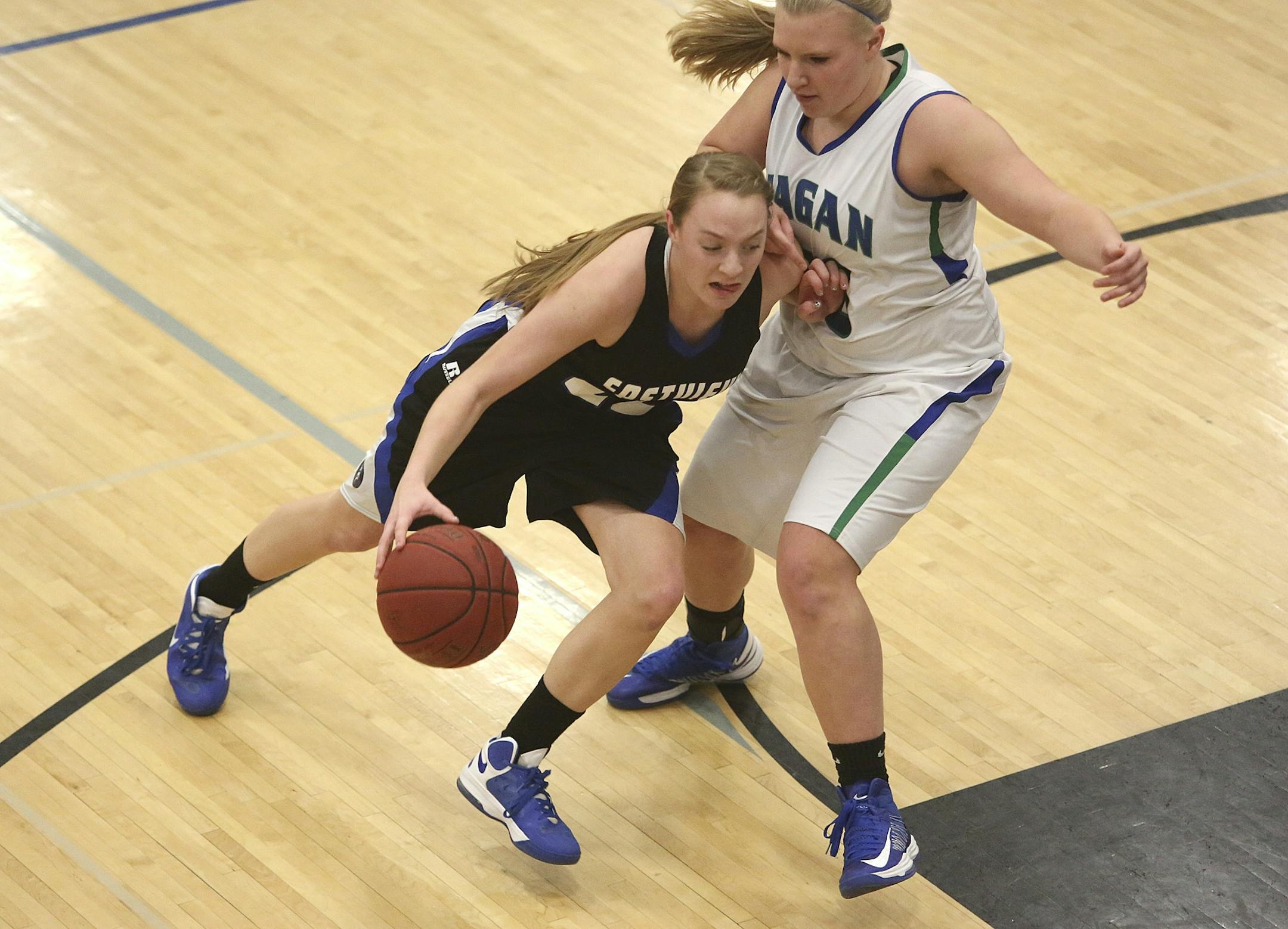 Eastview's Madison Guebert drove the lane at Eagan's Dani Bischoff.