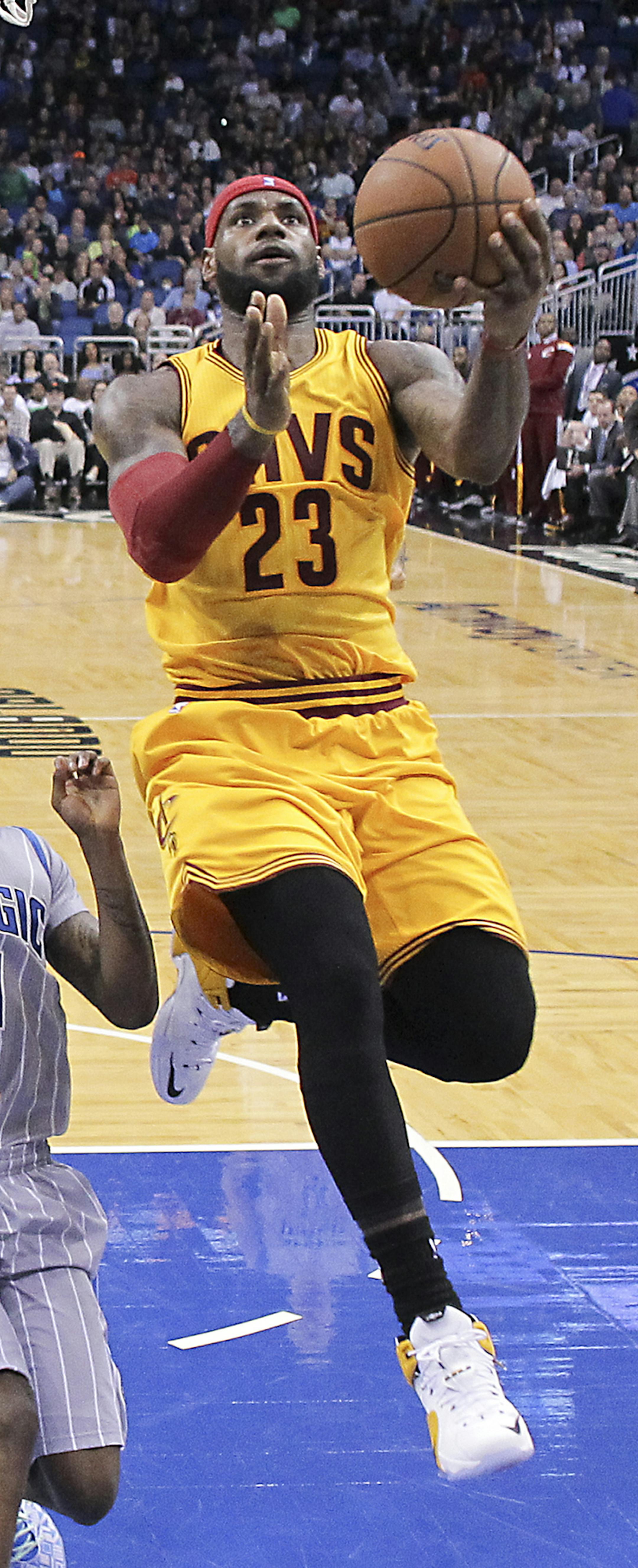 Cleveland Cavaliers' LeBron James (23) makes a shot as he gets past Orlando Magic's Elfrid Payton (4) during the second half of an NBA basketball game, Friday, Dec. 26, 2014, in Orlando, Fla. Cleveland won 98-89. (AP Photo/John Raoux) ORG XMIT: DOA