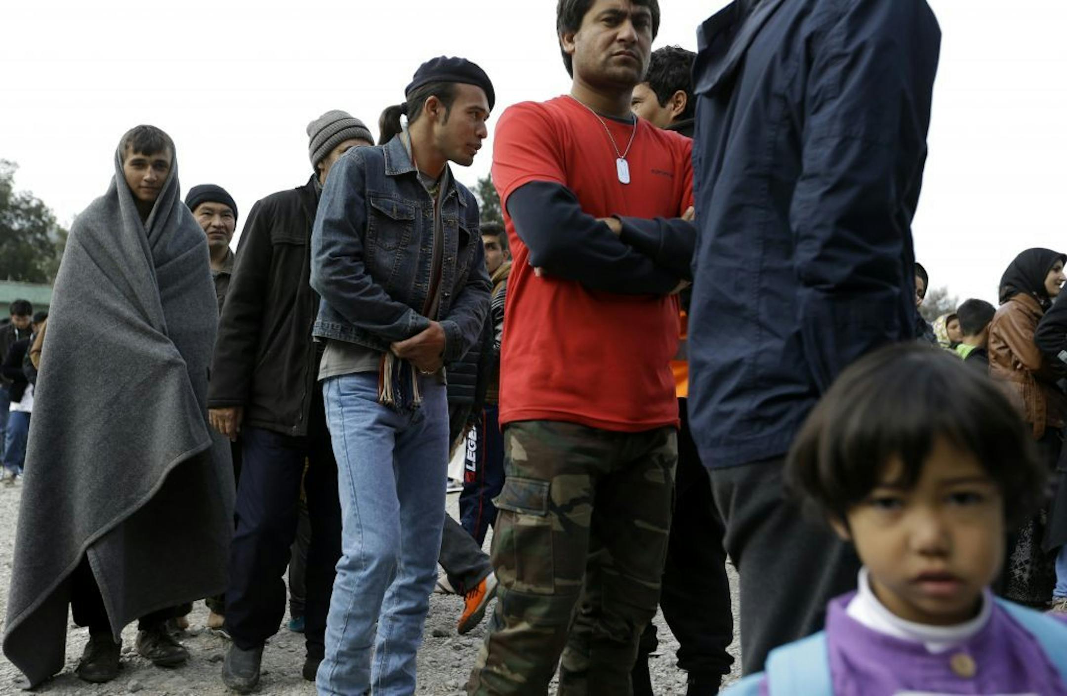 Migrants from Afghanistan, wait in queues to receive food distributed by the Greek army at a refugee camp in the western Athens' suburb of Schisto, Thursday, March 17, 2016. European Union leaders will push ahead Thursday with contested plans to send tens of thousands of migrants back to Turkey amid deep divisions over how to manage Europe's biggest refugee emergency in decades.