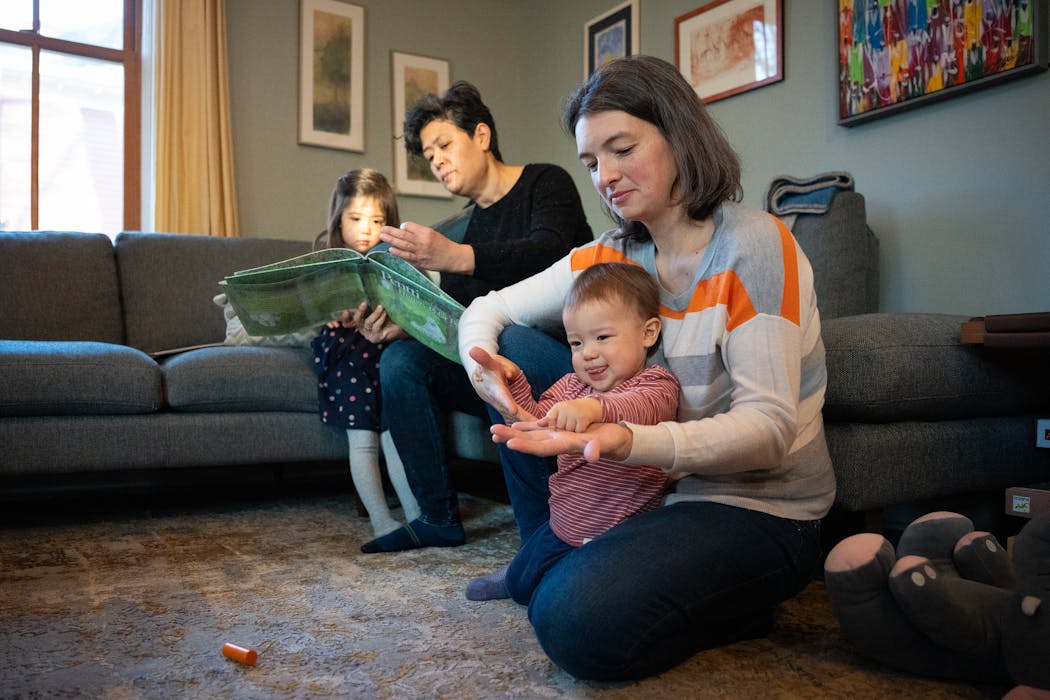 Rebecca Albers, right, and Maiya Papach during a rare weekday morning home with both children.. Albers and Papach fell in love at a classical music festival.