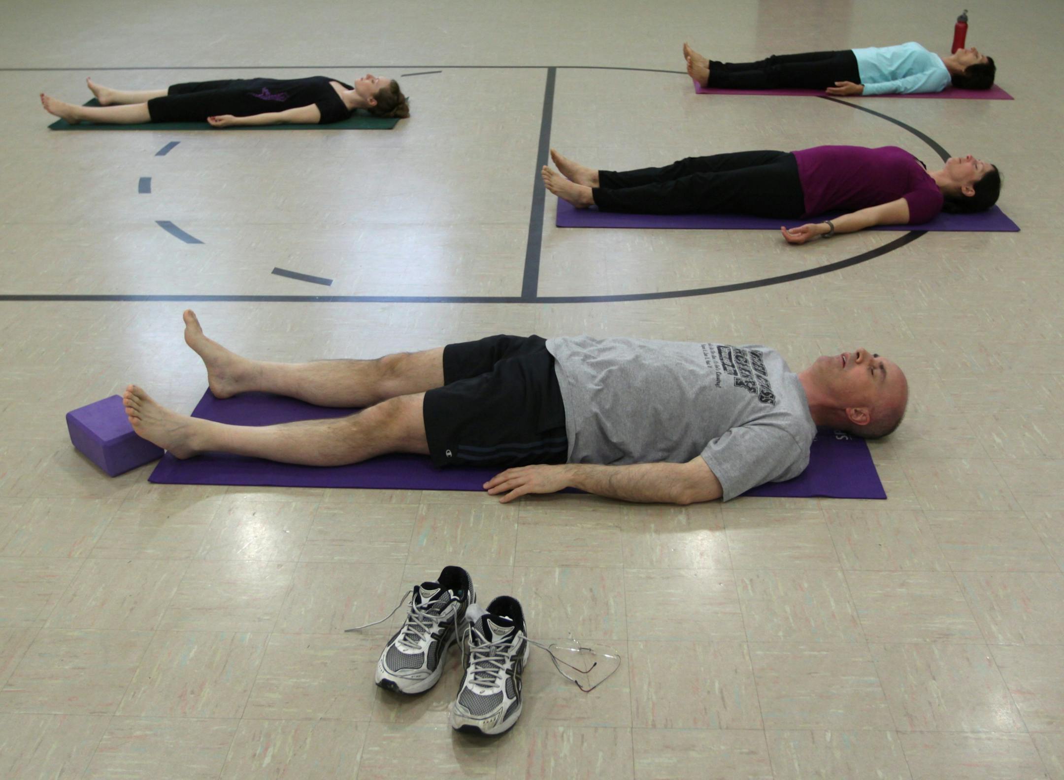 (left to right) Erin Marth Marty Anderson, Deb McMahon and Judy Besch meditated at the start of the Holy Yoga class at the Elim Lutheran Church in Robbinsdale.
