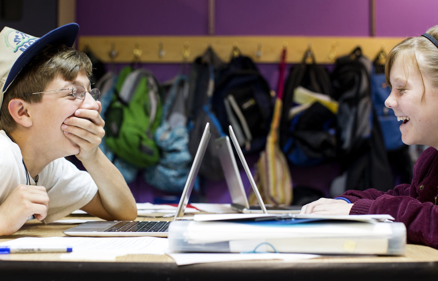 Alden Cristofaro-Hart, 12, left, and Nissa Christianson, 11, share a laugh as they work on laptops during class at Arcadia Charter School in Northfield October 8, 2013. (Courtney Perry/Special to the Star Tribune)