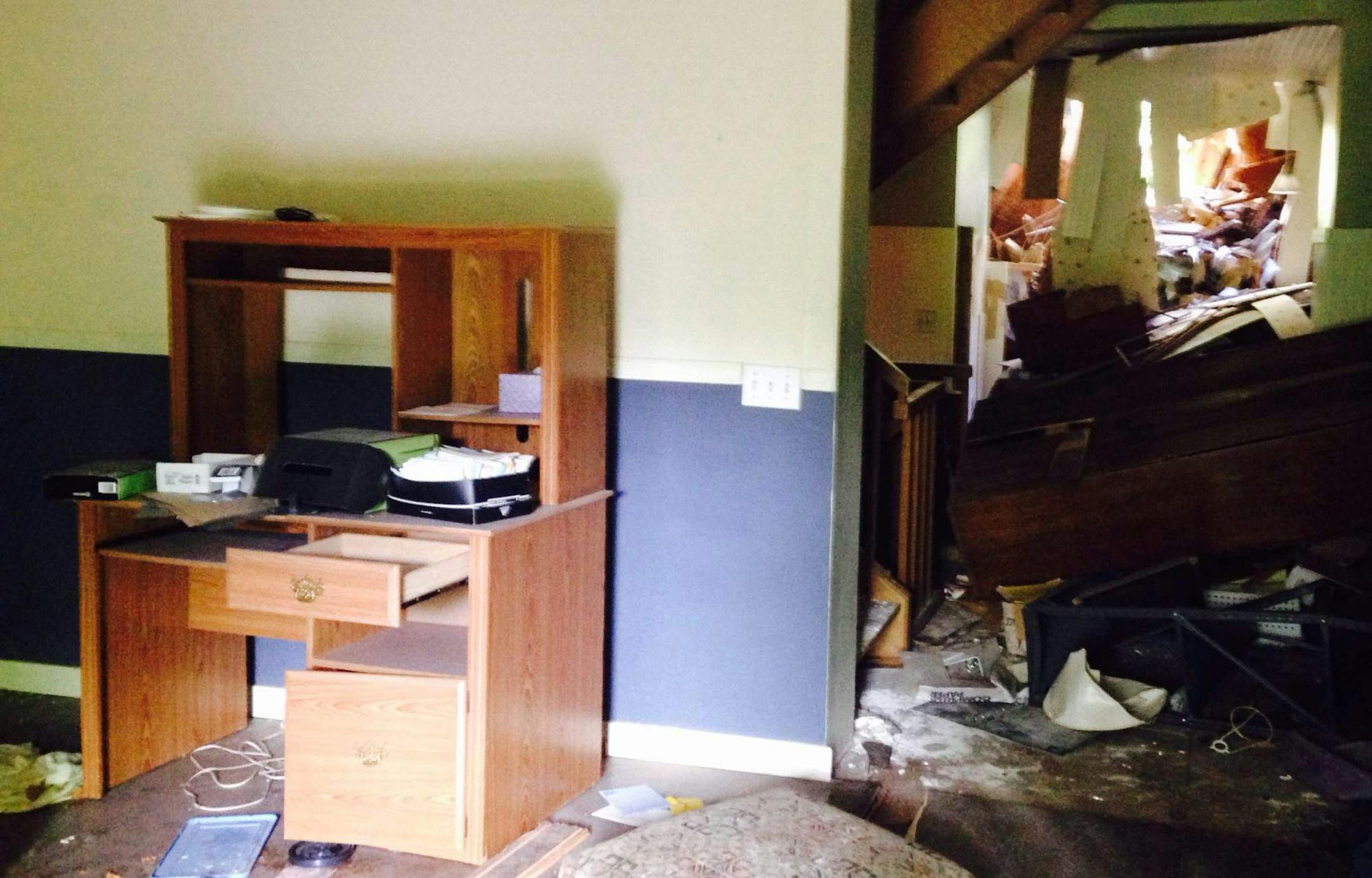 The Boutwell House was occupied until recently and will require cleaning and reconstruction of the back of the house, where demolition had started in January. At right is Brent Peterson of the Washington County Historical Society.