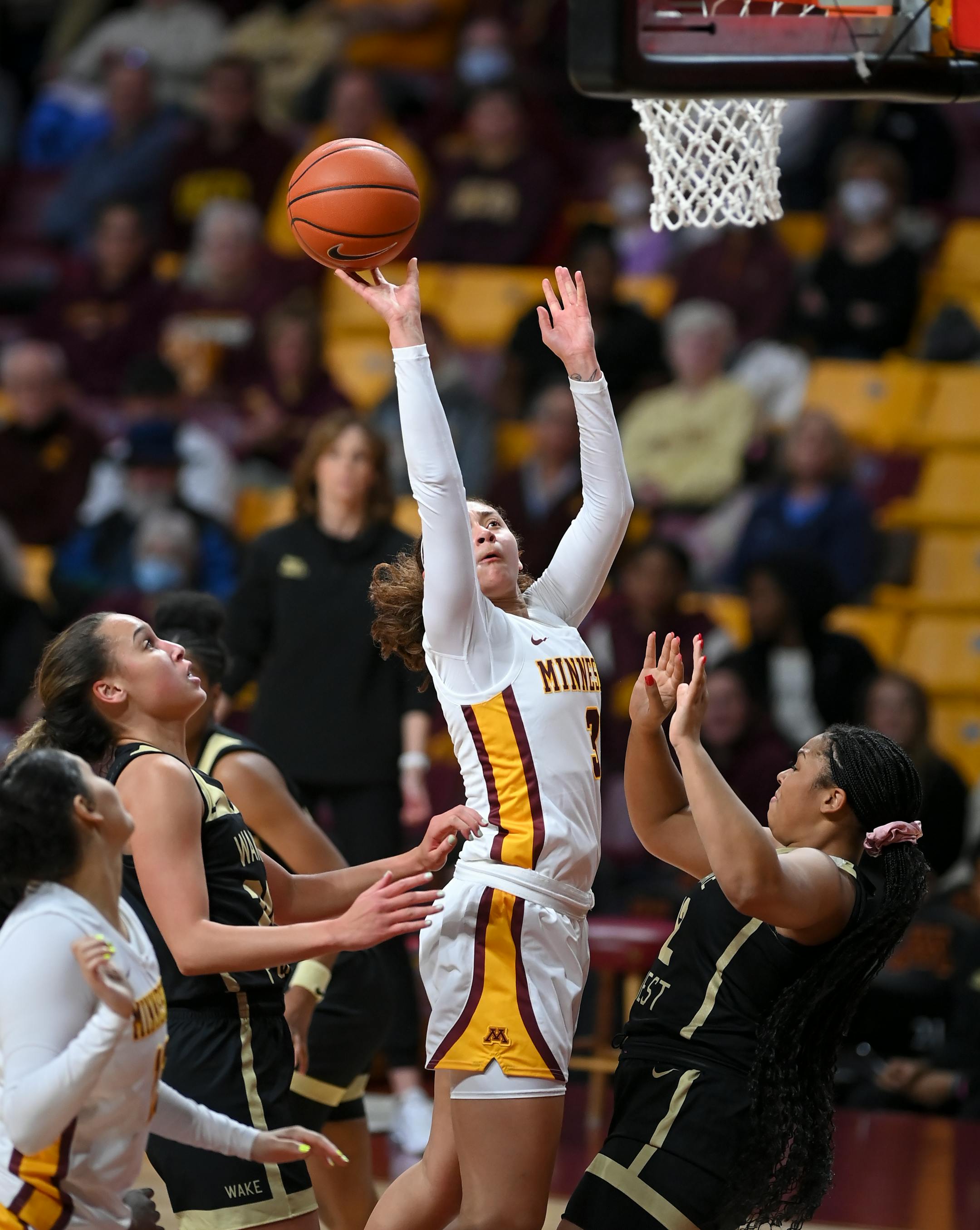 Minnesota Gophers guard Amaya Battle (3) is fouled by Wake Forest guard Alexandria Scruggs (32) as she scores a basket for an and-one opportunity during the first half.