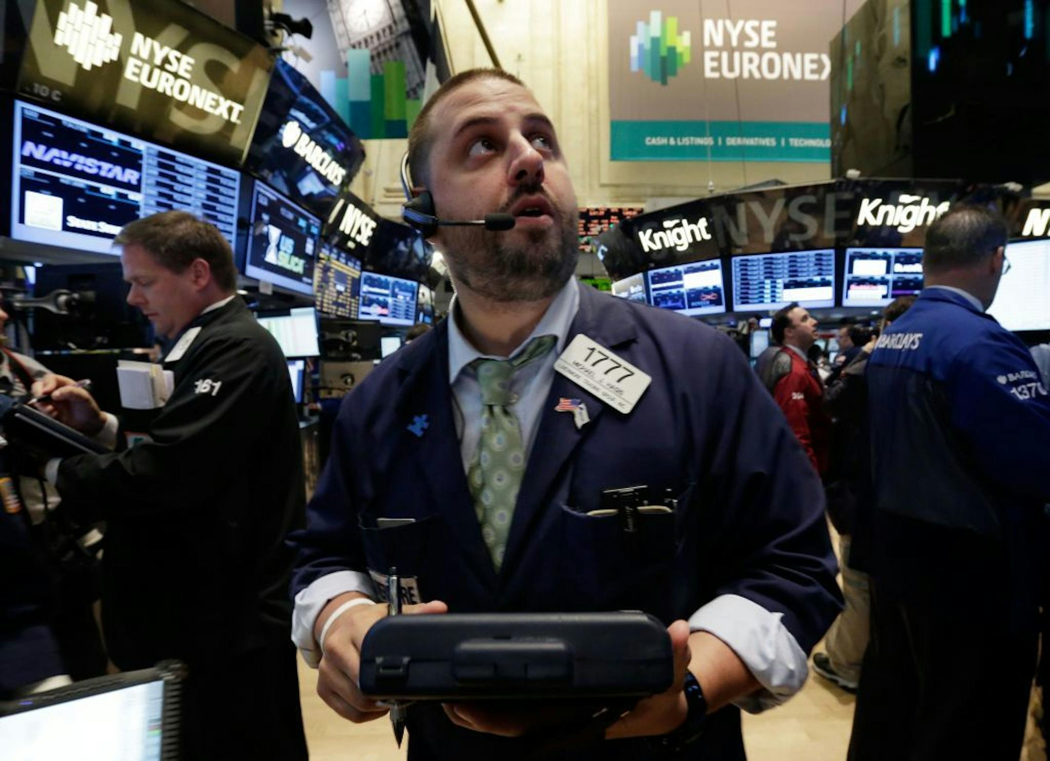 Trader Michael Hagis works on the floor of the New York Stock Exchange Tuesday, June 11, 2013. Stocks are falling in early trading on Wall Street, following global markets lower after the Bank of Japan declined to take further action to shore up that country's financial system.