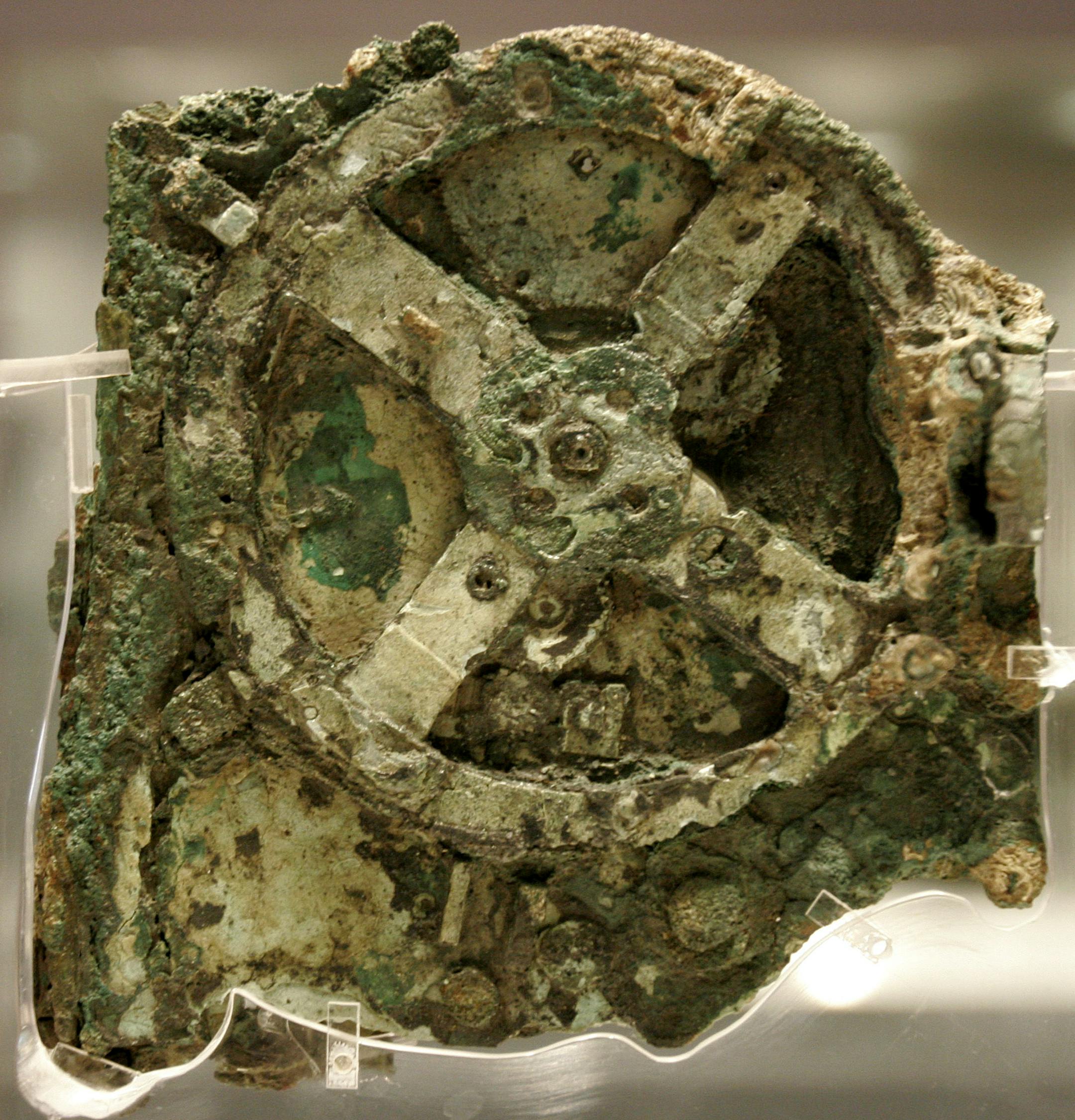 A fragment of the 2,100-year-old Antikythera Mechanism, believed to be the earliest surviving mechanical computing device, is seen at the National Archaeological Museum in Athens, Thursday, Nov. 30, 2006. The bronze system of cogs and wheels was found in a Roman wreck off southern Greece in 1900. It is the focus of a two-day conference starting in Athens late Thursday, with the participation of scientists from Greece, Britain, the U.S. and other countries. (AP Photo/Thanassis Stavrakis) ORG XMIT